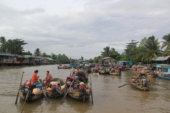 1-day Mekong Delta Tour: Cai Be Market, Local Island and Cycling - The larger boat and the small sampan