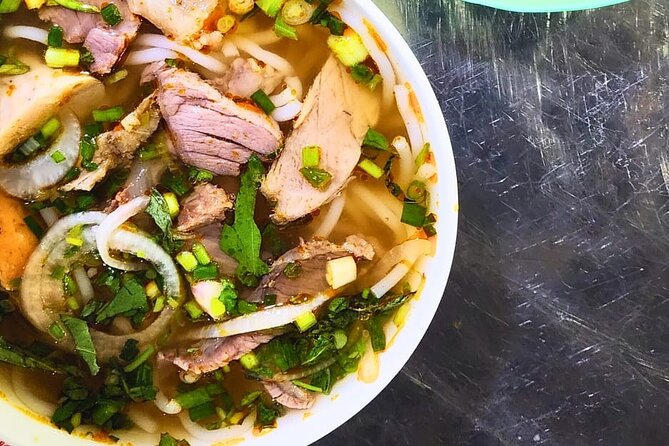 Saigon Food Tour by Scooter with Eleven Tastings - Nguyen Thien Thuat apartments and a bowl of bún bò Huế
